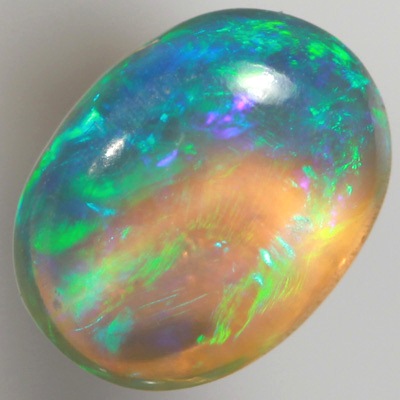 SOLID CRYSTAL OPAL Rolling flashes of green and turquoise with a purple hue